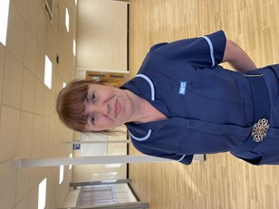 Photo of Anne Reddington wearing a mid blue tunic with light blue pipin