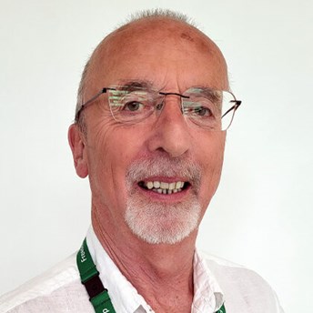Photo of head and shoulders shot of Meredydd David who has a goatee and is  wearing a white shirt
