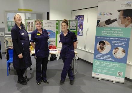 Photo of research team with stall at arrowe park hospital for clinical trials day