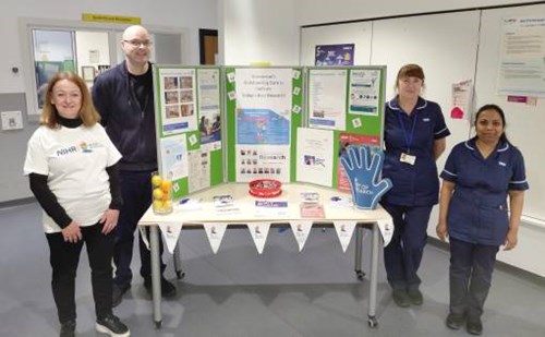 Photo of research team with stall at arrowe park hospital for clinical trials day